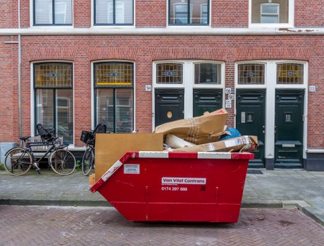 Business professionals handling waste in an office setting